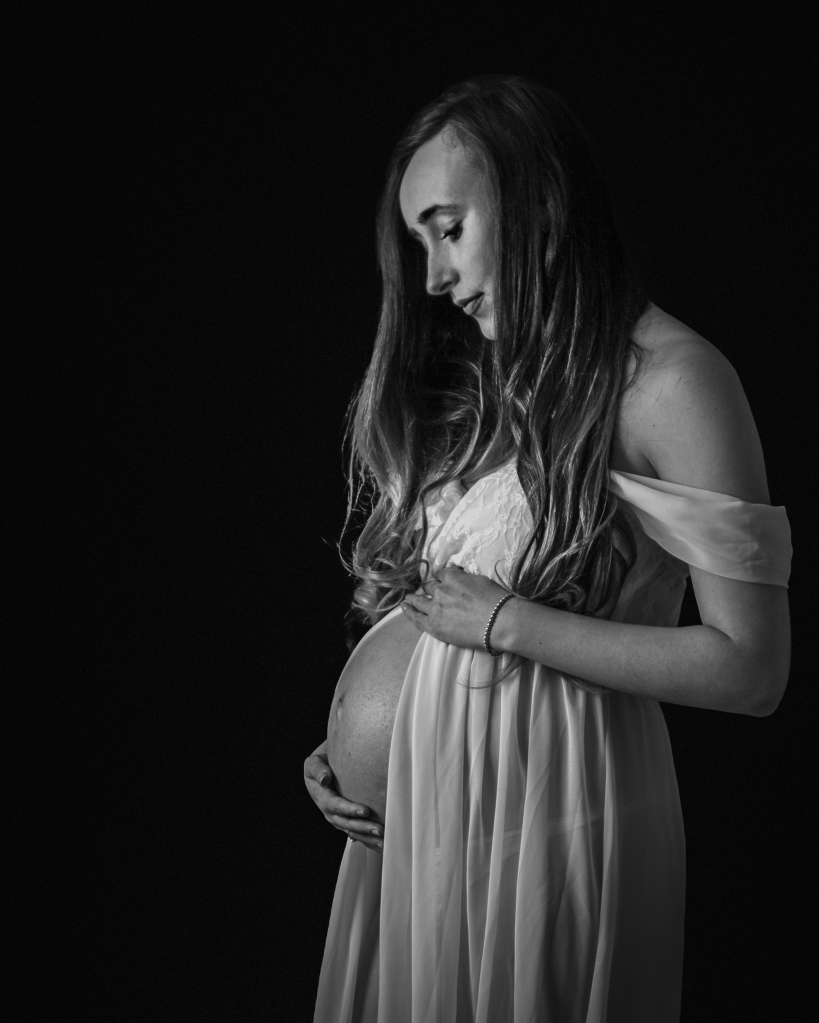 a mother lovingly holding her bump