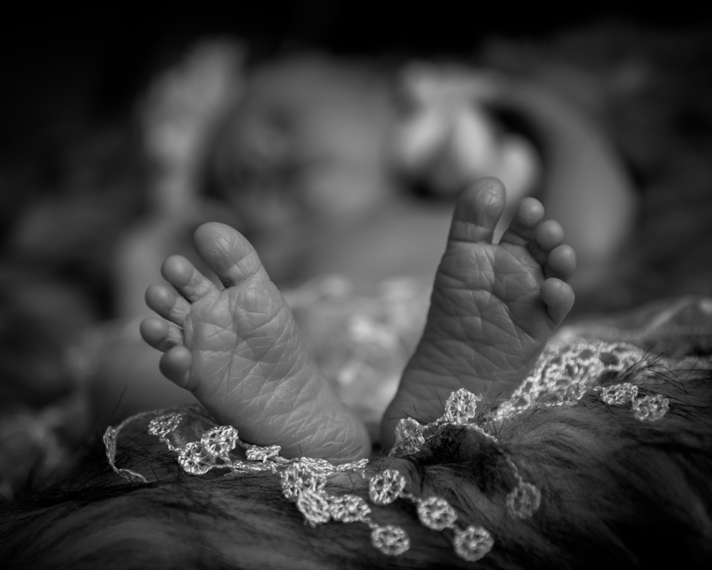 A new born baby's tiny and wrinkly feet
